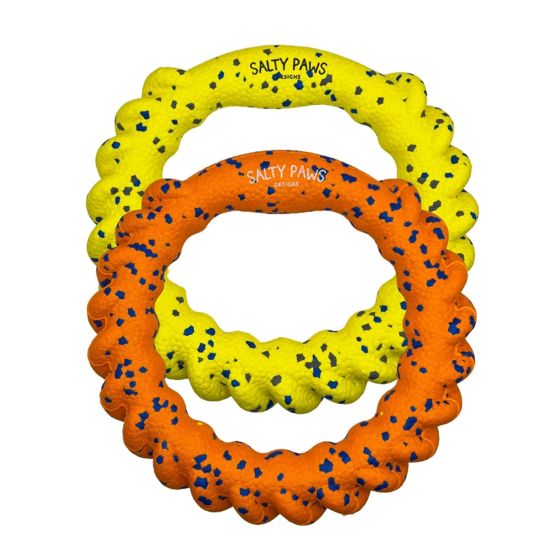 Two ETPU dog toy rings in bright yellow and orange, both speckled with small blue flecks. Both have the brand name 'SALTY PAWS' printed on it.