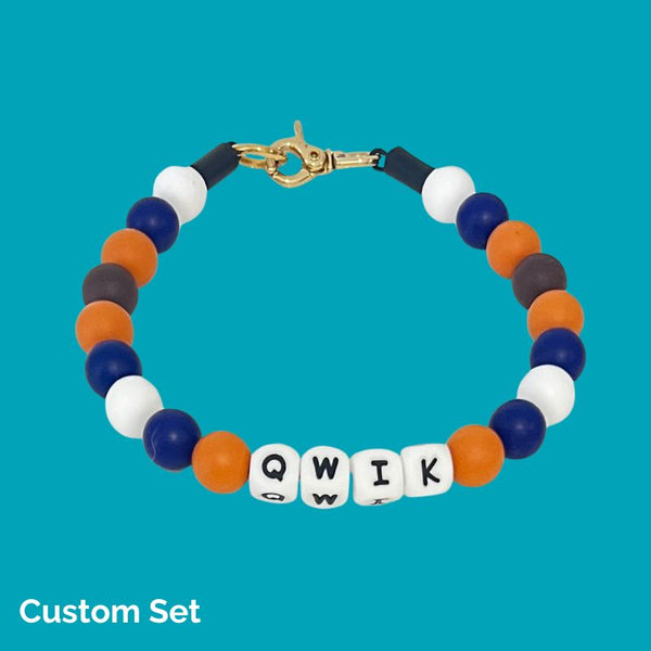 Colorful beaded bracelet with letter beads on a blue background