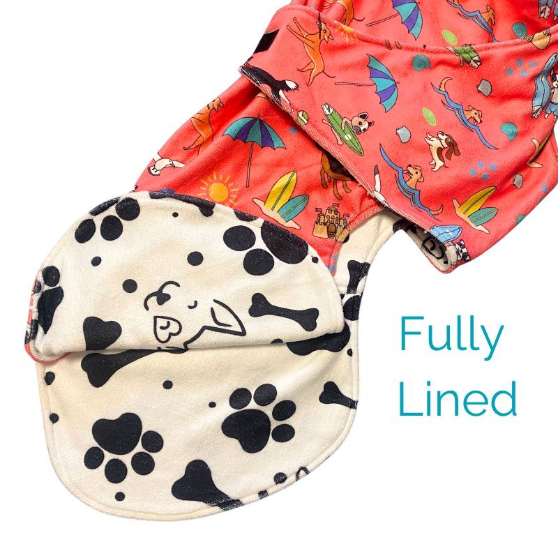 Salty Paws Dog Drying Coat showing fully lined paw print interior with coral outer fabric detail