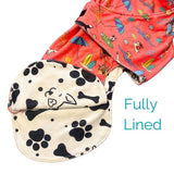 Salty Paws Dog Drying Coat showing fully lined paw print interior with coral outer fabric detail