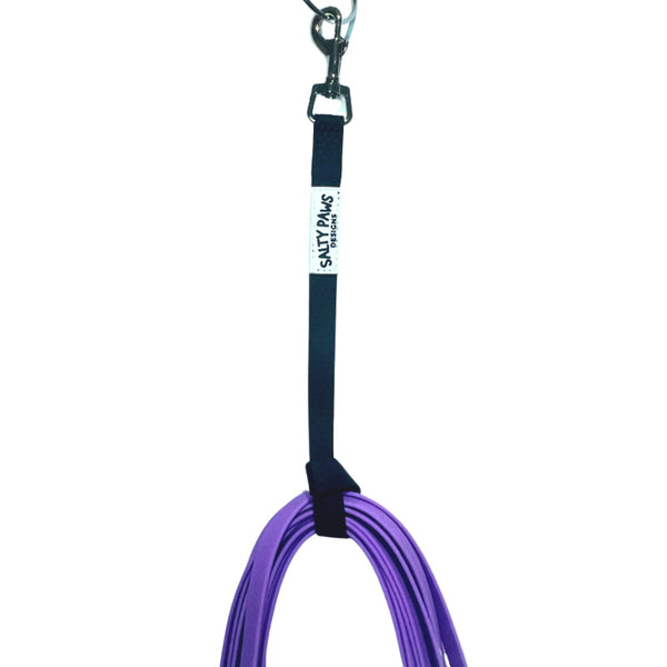Salty Paws long line lead storage strap close up showing carabiner clip and Salty Paws label