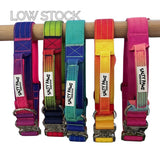 Salty Paws ombré tactical dog collars in all available colours with aluminium hardware displayed on wooden rail.