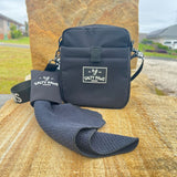 Salty Paws Original Dog Training Treat Pouch with Slobber Towel laid out on sandstone surface, outdoor lifestyle