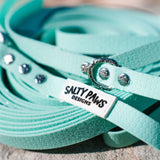 Salty Paws quick release waterproof long line lead in mint, coiled lifestyle shot showing brand label and hardware detail