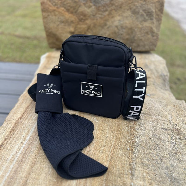Salty Paws Slobber Towel clipped onto the Original Dog Training Treat Pouch, black, on a rock