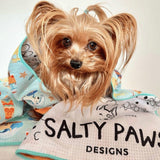 Yorkshire Terrier wrapped in Salty Paws Surf's Up Adventure Dog Towel in mint showing paw print reverse lining
