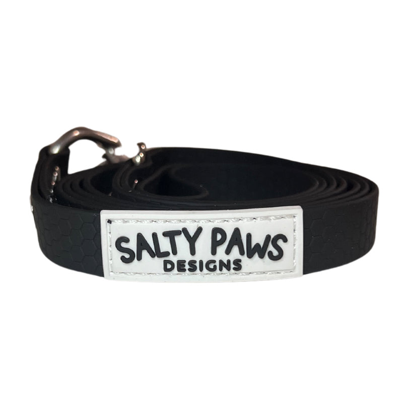 Salty Paws waterproof long line dog lead in black, coiled with silver hardware