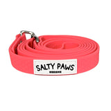 Salty Paws waterproof long line dog lead in coral, coiled with silver hardware
