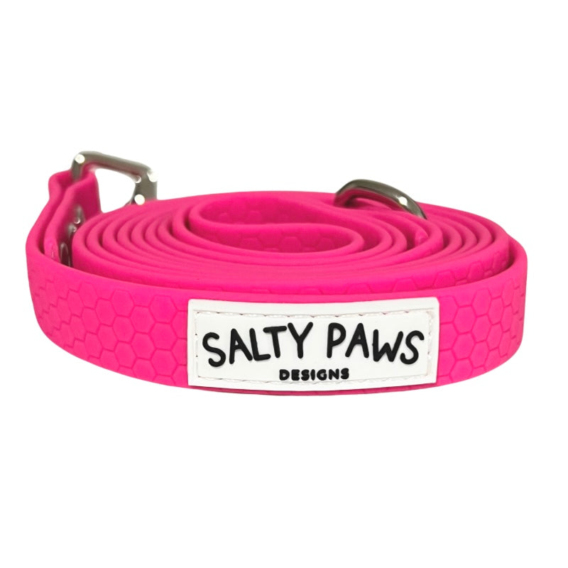 Salty Paws waterproof long line dog lead in hot pink, coiled with silver hardware