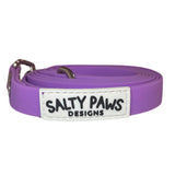 Salty Paws waterproof long line dog lead in purple, coiled with silver hardware