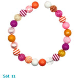 Colorful beaded dog necklace with various patterns on a white background