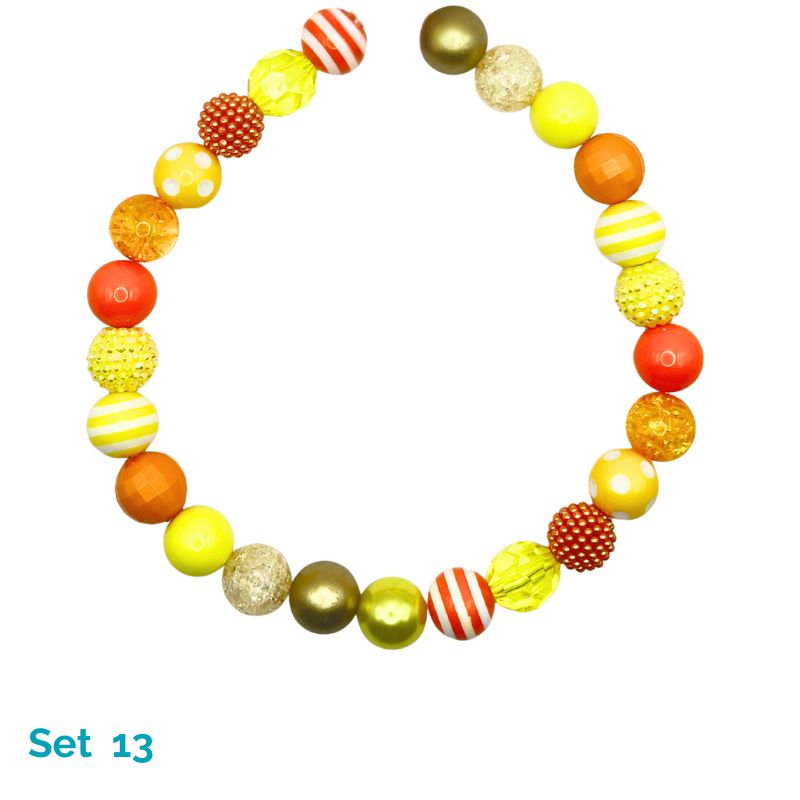 Colorful beaded dog necklace with various patterns on a white background