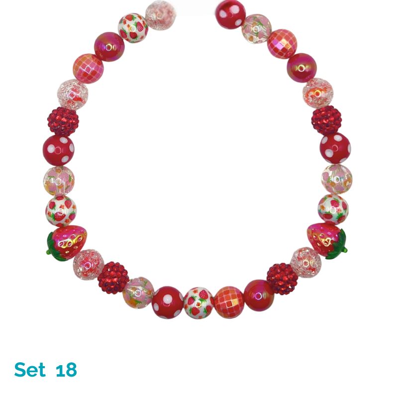 Colorful bead necklace with strawberry design on a white background