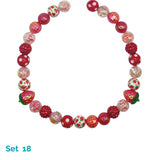 Colorful bead necklace with strawberry design on a white background