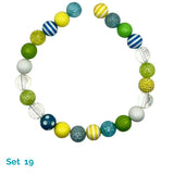 Colorful beaded dog necklace with various patterns on a white background