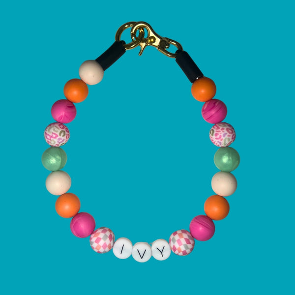 Colorful beaded bracelet with a gold clasp on a blue background