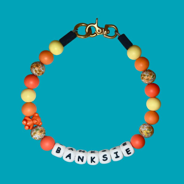 Colorful beaded bracelet with 'BANKSIE' on a blue background