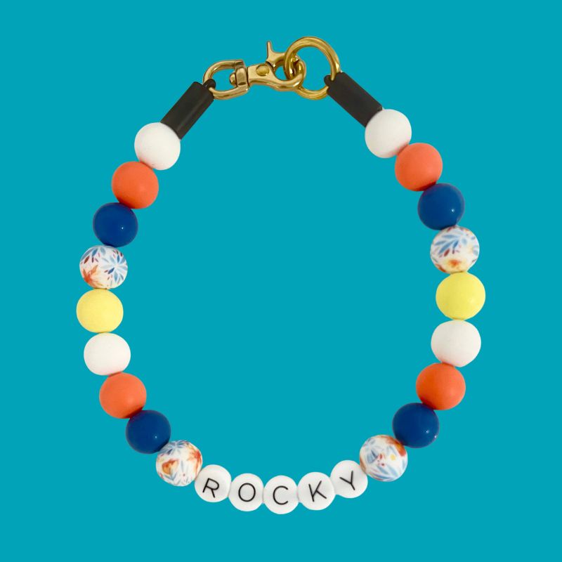 Colorful beaded bracelet with 'ROCKY' on a blue background
