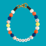 Colorful beaded bracelet with 'ROCKY' on a blue background