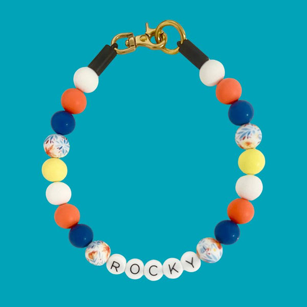 Colorful beaded bracelet with 'ROCKY' on a blue background