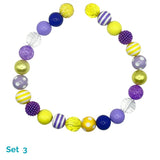 Colorful beaded dog necklace with various patterns on a white background