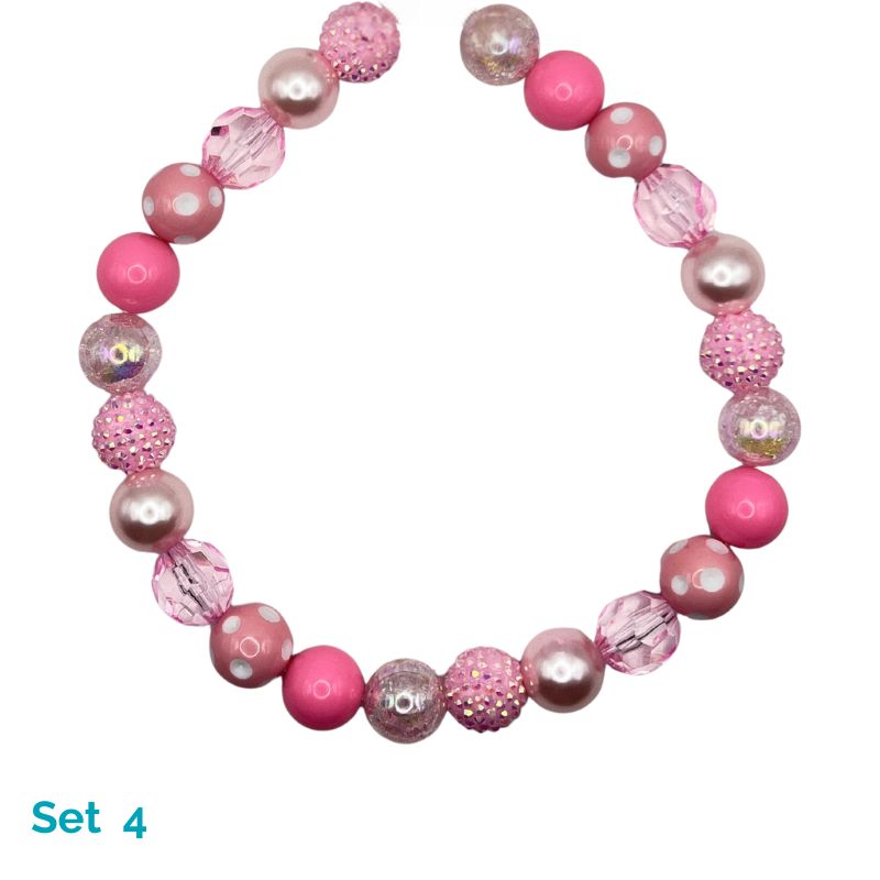 Pink beaded dog necklace on a white background