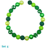 Green and yellow beaded dog necklace on a white background