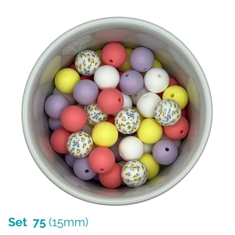 A top-down view of a white bowl filled with 15mm round beads in pastel colors, including pink, yellow, purple, white, and floral-patterned beads. Text in the bottom-left corner reads 'Set 75 (15mm)'.