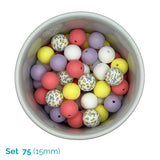 A top-down view of a white bowl filled with 15mm round beads in pastel colors, including pink, yellow, purple, white, and floral-patterned beads. Text in the bottom-left corner reads 'Set 75 (15mm)'.