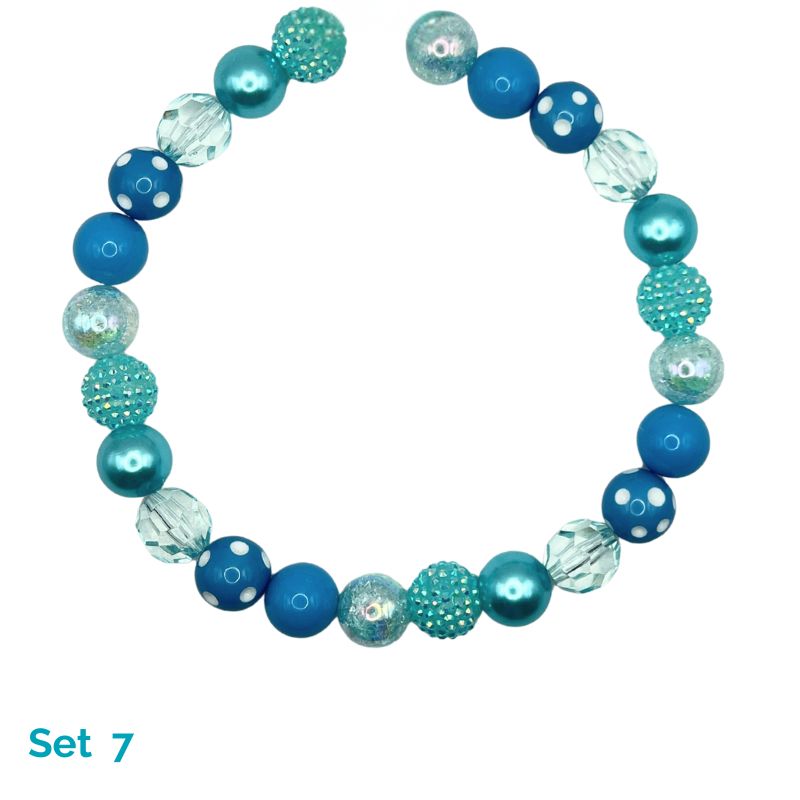 Beaded dog necklace with blue and clear beads on a white background