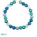 Beaded dog necklace with blue and clear beads on a white background
