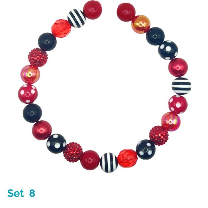 Colorful beaded bracelet with red, black, and white beads on a white background