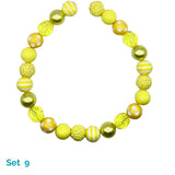 Yellow and white beaded dog necklace on a white background