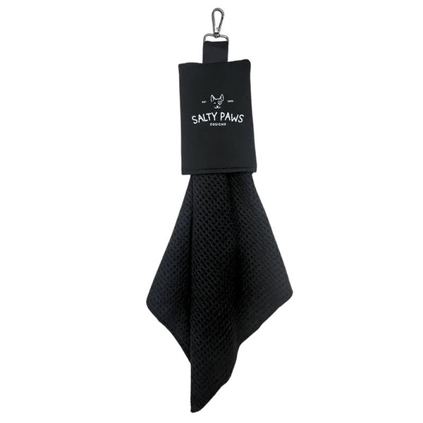 Salty Paws Slobber Towel in black hanging from a carabiner clip, waffle-knit fabric, compact dog towel
