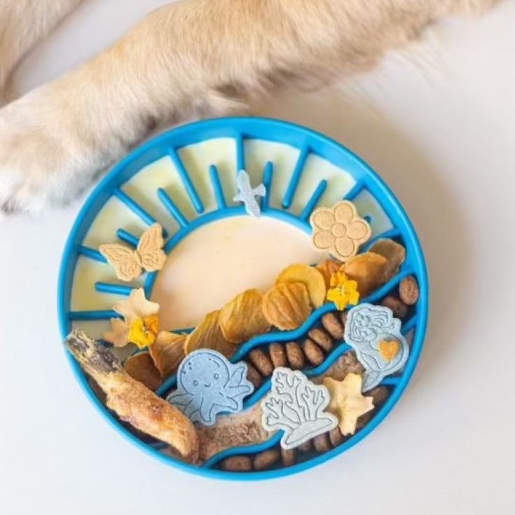 Sunset Slow Feeder in blue filled with treats and enrichment food for dogs