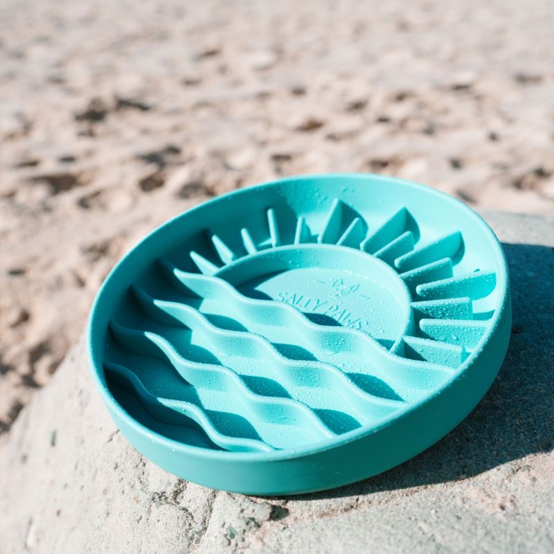Salty Paws Sunset Slow Feeder in green on sandy surface showing sun and beach wave pattern